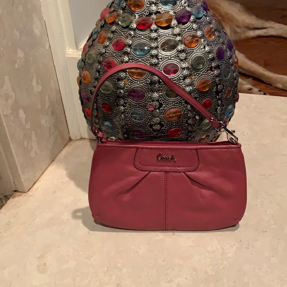 Coach mini handbag rose color interior pockets like new condition.